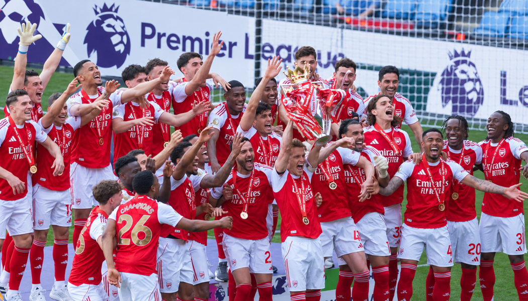 Arsenal players celebrate with the Premier League trophy after winning the 2025/26 title