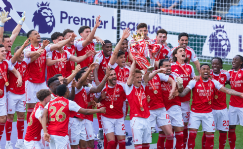 Arsenal players celebrate with the Premier League trophy after winning the 2025/26 title