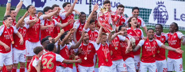 Arsenal players celebrate with the Premier League trophy after winning the 2025/26 title