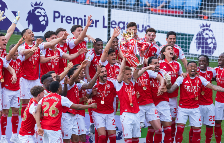 Arsenal players celebrate with the Premier League trophy after winning the 2025/26 title
