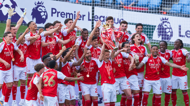 Arsenal players celebrate with the Premier League trophy after winning the 2025/26 title