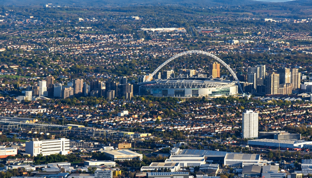 Aerial view of Wembley Stadium and its arch, surrounded by north-west London