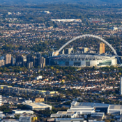 Aerial view of Wembley Stadium and its arch, surrounded by north-west London
