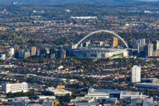Aerial view of Wembley Stadium and its arch, surrounded by north-west London