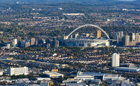 Aerial view of Wembley Stadium and its arch, surrounded by north-west London