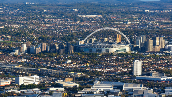 Aerial view of Wembley Stadium and its arch, surrounded by north-west London