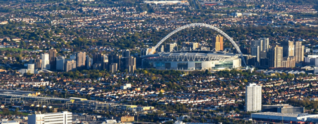 Aerial view of Wembley Stadium and its arch, surrounded by north-west London